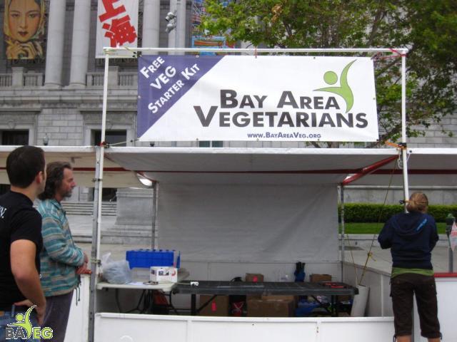 Michelle finishing setup on the banner while Dan and George check if its straight