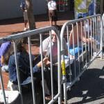 Waiting for the parade and reading a VSK from pre-parade leafleting by Ann, Katherine, Mila, Reeba and Tammy 