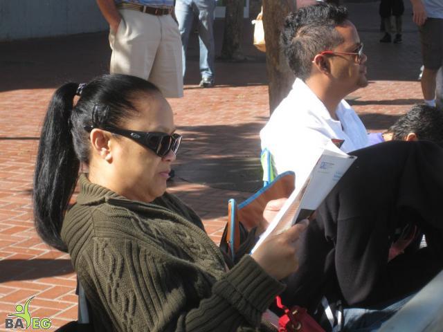 Waiting for the parade and reading a VSK from pre-parade leafleting by Ann, Katherine, Mila, Reeba and Tammy