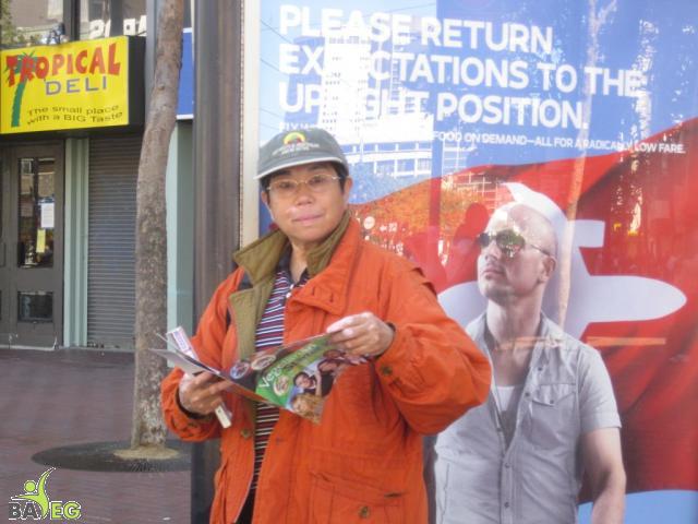 Waiting for the parade and reading a VSK from pre-parade leafleting by Ann, Katherine, Mila, Reeba and Tammy