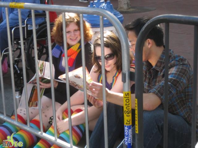 Waiting for the parade and reading a VSK from pre-parade leafleting by Ann, Katherine, Mila, Reeba and Tammy