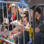 Waiting for the parade and reading a VSK from pre-parade leafleting by Ann, Katherine, Mila, Reeba and Tammy