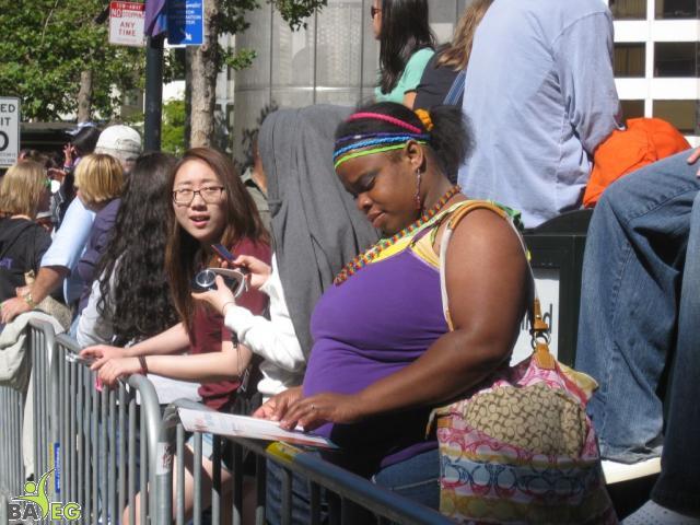 Waiting for the parade and reading a VSK from pre-parade leafleting by Ann, Katherine, Mila, Reeba and Tammy