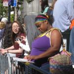 Waiting for the parade and reading a VSK from pre-parade leafleting by Ann, Katherine, Mila, Reeba and Tammy