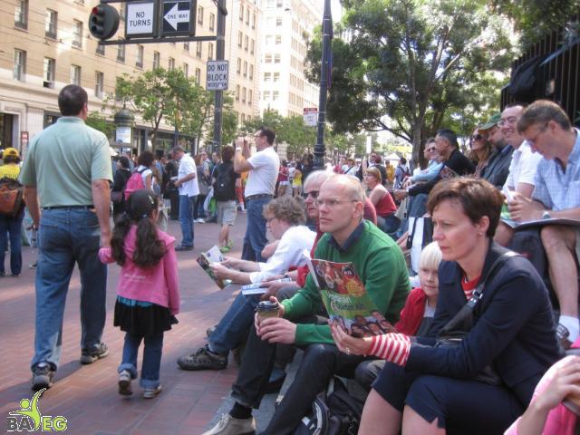 Waiting for the parade and reading a VSK from pre-parade leafleting by Ann, Katherine, Mila, Reeba and Tammy