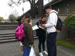 Students reading leaflets
