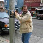 Warren putting up Peaceable Kingdom Posters - July 04
