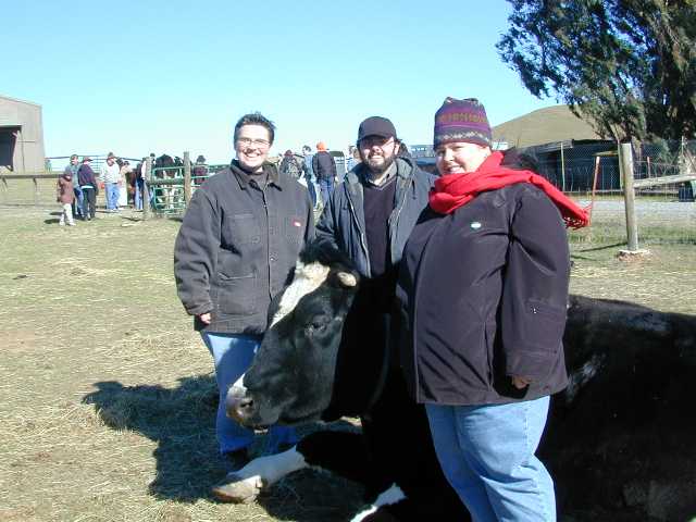 Regina, Chris, and Nicole with bovine friend